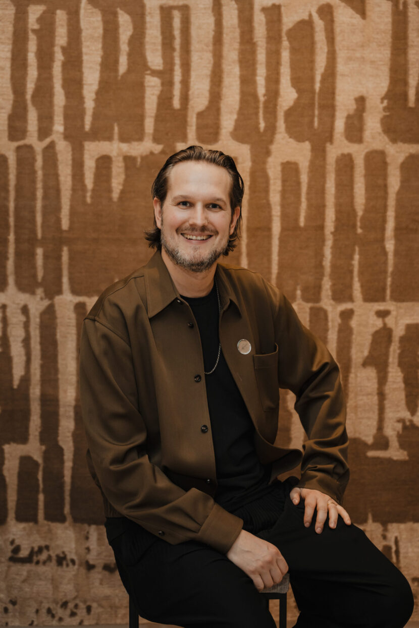 Sebastian Herkner in front of his rug in the Caspaiou showroom.